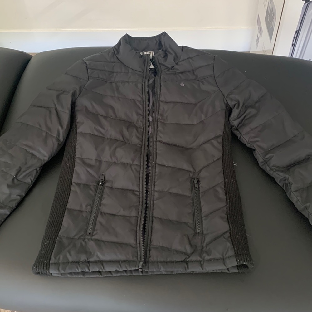 Black insulated ski or casual jacket.Short waisted